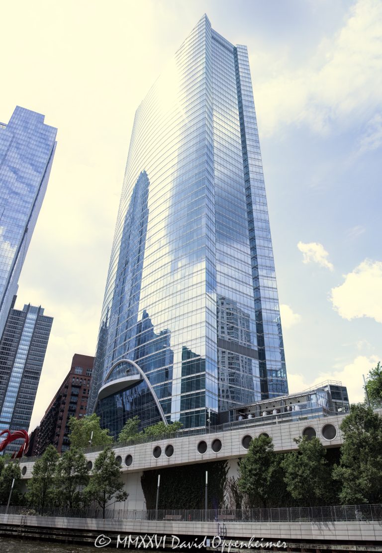 River Point at 444 West Lake Street rises along the Chicago River in the West Loop, with a curved glass office tower facade, riverboat traffic, and riverfront public space visible in the foreground. Designed by Pickard Chilton with Kendall/Heaton Associates and developed by Hines, the Class A office skyscraper includes River Point Park and Santiago Calatrava’s Constellation sculpture on the riverfront – © 2026 David Oppenheimer – Performance Impressions photography archives https://performanceimpressions.com River Point 444 West Lake Street, River Point, River Point Chicago, River Point tower, River Point office tower, 444 West Lake Street, 444 W Lake Street, 444 W Lake St, 444 West Lake, 444 W Lake, 200 North Riverside Plaza, 200 N Riverside Plaza, West Loop Chicago, West Loop, downtown Chicago, Chicago Illinois, Chicago IL, West Lake Street, Lake Street, North Canal Street, Canal Street, Chicago River, river, riverfront, waterfront, Chicago riverfront, Chicago waterfront, South Branch Chicago River, River Point Park, riverfront park, public plaza, riverside plaza, riverwalk, Riverwalk, riverboat, river boat, boats, boat, water, waterway, 60606, facade, building exterior, exterior, glass facade, curved glass, curved facade, reflective glass, office tower, office building, commercial building, Class A office, skyscraper, high rise, tower, real estate, Chicago real estate, commercial real estate, office real estate, riverfront real estate, waterfront real estate, architecture, architectural photography, Chicago architecture, riverfront architecture, contemporary architecture, commercial architecture, Pickard Chilton, Kendall Heaton, Kendall Heaton Associates, Hines, Hines Interests, Ivanhoe Cambridge, Levy Organization, Lendlease, Magnusson Klemencic, Santiago Calatrava, Constellation sculpture, public art, sculpture, urban waterfront, urban design, Chicago skyline, Illinois architecture, United States, licensing, image licensing, commercial imagery, photography licensing, art, print, fine art, commercial photography, David Oppenheimer, vertical, 1-15156784411