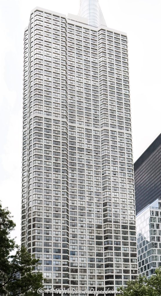 River Plaza at 405 North Wabash Avenue and Renelle on the River rise along the Chicago River in River North, showing a dense residential tower scene with glass facade, riverfront real estate, river traffic, and public art in view. River Plaza is a Gordon & Levin residential condominium tower, while nearby Renelle on the River is a bKL Architecture luxury condominium tower at 403 North Wabash Avenue – © 2026 David Oppenheimer – Performance Impressions photography archives https://performanceimpressions.com River Plaza, River Plaza Chicago, River Plaza condos, River Plaza condominiums, 405 N Wabash Ave, 405 North Wabash Avenue, 405 N Wabash, North Wabash Avenue, Wabash Avenue, Renelle on the River, Renelle Chicago, Renelle condos, Renelle condominiums, 403 N Wabash Ave, 403 North Wabash Avenue, River North, River North Chicago, downtown Chicago, Chicago Illinois, Chicago IL, Chicago River, river, riverfront, waterfront, Chicago riverfront, Chicago waterfront, Riverwalk, Chicago Riverwalk, 60611, facade, building exterior, exterior, glass facade, residential facade, tower, residential tower, condo tower, condominium tower, high rise, skyscraper, residential building, condo building, condominium building, luxury condos, luxury condominiums, condos, condominiums, real estate, Chicago real estate, River North real estate, residential real estate, riverfront real estate, waterfront real estate, housing, residential housing, riverboat, river boat, boat, boats, water, waterway, public art, sculpture, urban waterfront, urban living, city living, architecture, architectural photography, Chicago architecture, riverfront architecture, residential architecture, modern architecture, contemporary architecture, Gordon & Levin, Gordon and Levin, Ezra Gordon, Jack Levin, bKL Architecture, Belgravia Group, McHugh Construction, River Plaza Homeowners Association, Illinois architecture, United States, licensing, image licensing, commercial imagery, photography licensing, art, print, fine art, commercial photography, David Oppenheimer, vertical, 1-15156784411
