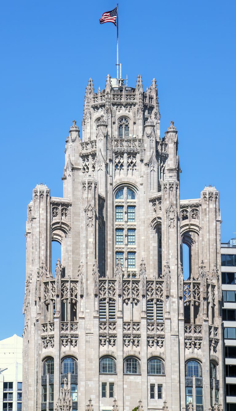 Tribune Tower at 435 North Michigan Avenue in Chicago shows the ornate neo-Gothic tower, limestone facade, Gothic crown, and architectural detailing of the former Chicago Tribune headquarters. Designed by John Mead Howells and Raymond Hood, the landmark tower has been converted into Tribune Tower Residences, a luxury condominium property developed by CIM Group and Golub & Company, with Rowan visible at Michigan Avenue street level – © 2026 David Oppenheimer – Performance Impressions photography archives https://performanceimpressions.com Tribune Tower, Tribune Tower Chicago, Tribune Tower Residences, Tribune Tower condos, Tribune Tower condominiums, 435 N Michigan Ave, 435 North Michigan Avenue, 435 N Michigan Avenue, North Michigan Avenue, Michigan Avenue, Magnificent Mile, Mag Mile, Chicago Loop, Streeterville, downtown Chicago, Chicago Illinois, Chicago IL, 60611, facade, building exterior, exterior, tower, Gothic tower, neo-Gothic tower, ornate tower, limestone facade, stone facade, Gothic facade, neo-Gothic facade, Gothic crown, architectural detail, ornate facade, historic facade, carved stone, buttresses, tracery, skyscraper, high rise, landmark building, Chicago Landmark, historic building, newspaper building, former headquarters, Chicago Tribune, Chicago Tribune Tower, Tribune Company, Tribune Media, Tribune Publishing, WGN Radio, real estate, Chicago real estate, luxury real estate, residential real estate, condominium tower, condo tower, luxury condos, condominiums, luxury residences, residential conversion, adaptive reuse, architecture, architectural photography, Chicago architecture, historic architecture, Gothic architecture, Gothic Revival, neo-Gothic architecture, commercial architecture, residential architecture, John Mead Howells, Raymond Hood, Howells and Hood, Howells & Hood, Rene Paul Chambellan, CIM Group, Golub and Company, Golub & Company, Rowan, Rowan Michigan Ave, Rowan Chicago, Tower District, Michigan Avenue retail, Chicago history, journalism history, Illinois architecture, United States, licensing, image licensing, commercial imagery, photography licensing, art, print, fine art, commercial photography, David Oppenheimer, vertical, 1-15156784411