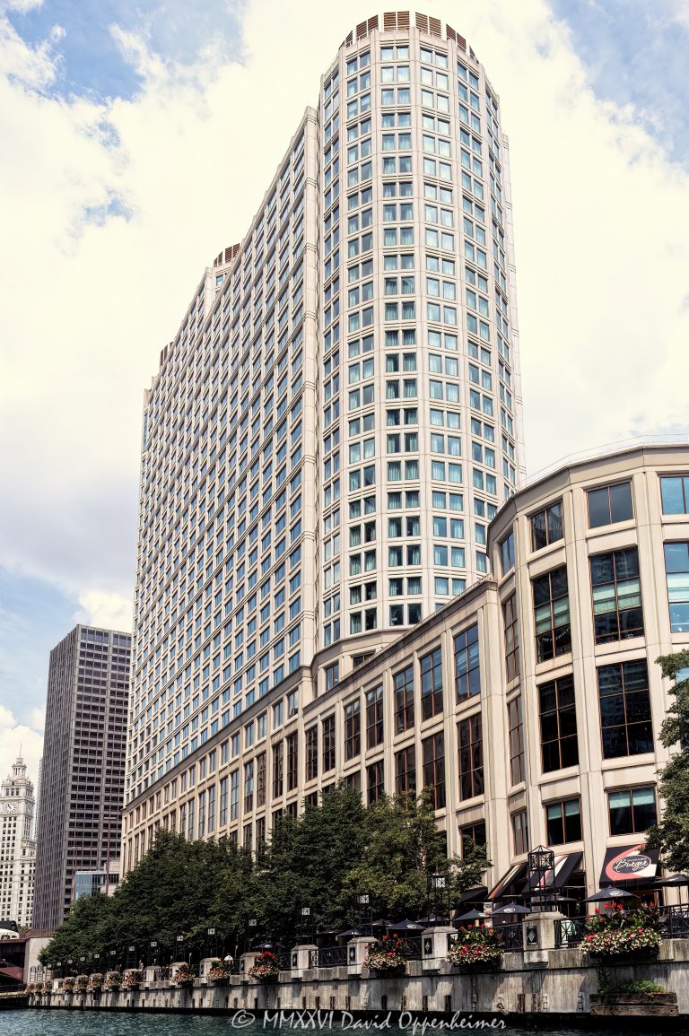 Sheraton Grand Chicago Riverwalk at 301 East North Water Street faces the Chicago River, with the Riverwalk, riverfront hotel facade, and water visible in the foreground. Operated under Marriott International’s Sheraton brand, the large downtown hotel is also known by its former name Sheraton Chicago Hotel & Towers and sits near Columbus Drive, Navy Pier, and the Magnificent Mile – © 2026 David Oppenheimer – Performance Impressions photography archives https://performanceimpressions.com Sheraton Grand Chicago Riverwalk, Sheraton Grand Chicago, Sheraton Chicago Hotel & Towers, Sheraton Chicago Hotel and Towers, Sheraton Chicago, 301 E North Water Street, 301 East North Water Street, 301 E North Water St, East North Water Street, North Water Street, Marriott, Marriott International, Marriott Bonvoy, Sheraton, Sheraton Hotels, Sheraton brand, River North, River North Chicago, Streeterville, Streeterville Chicago, downtown Chicago, Chicago Illinois, Chicago IL, Chicago River, river, riverfront, waterfront, water, Chicago riverfront, Chicago waterfront, Riverwalk, Chicago Riverwalk, riverwalk hotel, riverfront hotel, waterfront hotel, Chicago River hotel, downtown hotel, Chicago hotel, hotel, hotels, hospitality, travel, tourism, 60611, facade, building exterior, exterior, hotel facade, glass facade, modern facade, tower, hotel tower, high rise, skyscraper, commercial building, convention hotel, meeting hotel, event hotel, ballroom, Shula's Steak House, Navy Pier, Magnificent Mile, Columbus Drive, Lake Michigan, architecture, architectural photography, Chicago architecture, riverfront architecture, modern architecture, commercial architecture, Solomon Cordwell Buenz, SCB, Tishman Realty, Marriott hotel, luxury hotel, business travel, leisure travel, Illinois architecture, United States, licensing, image licensing, commercial imagery, photography licensing, art, print, fine art, commercial photography, David Oppenheimer, vertical, 1-15156784411