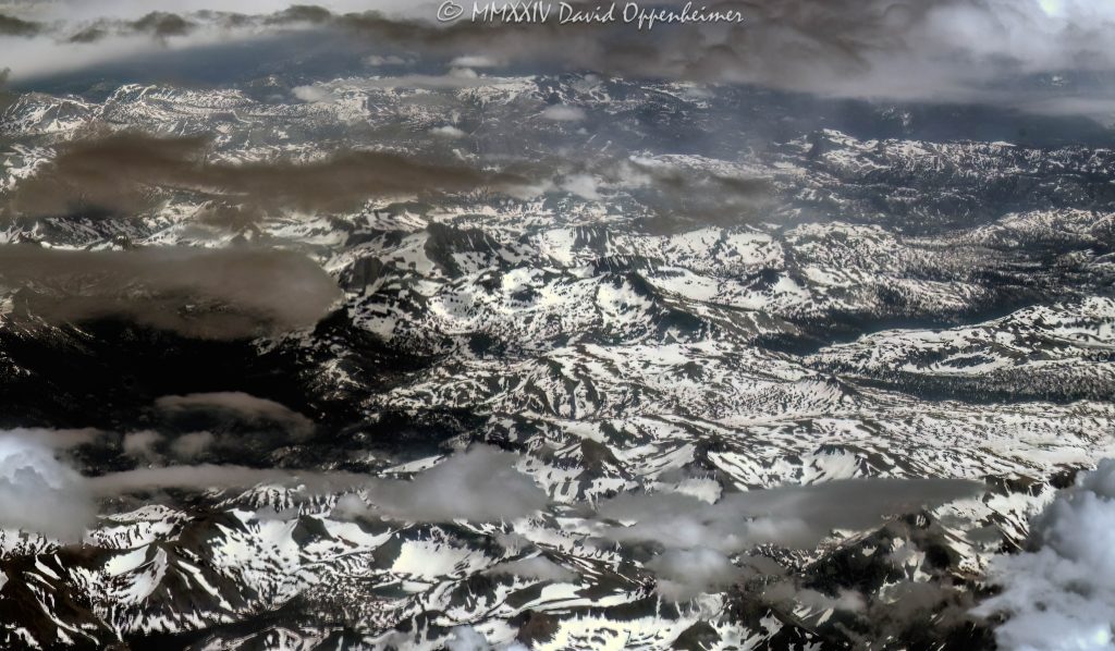 Sierra Nevada Mountains in California with Snow and Clouds Aerial View