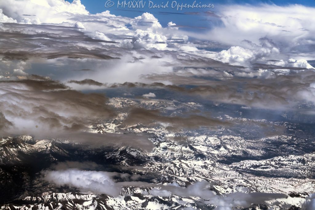 Sierra Nevada Mountains in California with Snow and Clouds Aerial View