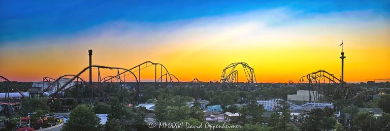 Six Flags Great America near Chicago in Gurnee, Illinois, viewed from Goliath at summer sunset with roller coasters and thrill rides silhouetted against a fiery red, orange, yellow, magenta and blue sky. Giant Drop rises at left and Sky Trek Tower with its American flag anchors the right, while Raging Bull, American Eagle, Maxx Force, Little Dipper and BATMAN: The Ride form the amusement park skyline below – © 2026 David Oppenheimer – Performance Impressions photography archives https://performanceimpressions.com Six Flags Great America, Six Flags Great America sunset, Six Flags sunset, Great America sunset, Six Flags Great America view, Great America view, Six Flags Great America Chicago, Great America Chicago, Six Flags Chicago, Six Flags Illinois, Great America Illinois, Six Flags, Great America, amusement park, theme park, amusement parks, theme parks, roller coaster, roller coasters, coaster, coasters, thrill ride, thrill rides, rides, amusement rides, theme park rides, park skyline, amusement park skyline, theme park skyline, roller coaster skyline, coaster skyline, ride skyline, Six Flags skyline, Great America skyline, sunset skyline, roller coaster silhouette, coaster silhouette, ride silhouette, silhouettes, silhouette, silhouetted rides, silhouetted coasters, sunset, summer sunset, fiery sunset, colorful sunset, sunset view, post sunset, dusk, twilight, blue hour, evening, summer, red sky, orange sky, yellow sky, magenta sky, purple sky, blue sky, colorful sky, sunset colors, dramatic sky, Goliath, Goliath roller coaster, Goliath Great America, Six Flags Goliath, Goliath coaster, Goliath view, view from Goliath, roller coaster view, coaster view, elevated view, high angle, aerial view, aerial perspective, bird’s-eye view, birds eye view, park overview, panoramic view, panorama, wide angle, landscape, Giant Drop, Giant Drop ride, Giant Drop tower, Six Flags Giant Drop, drop tower, drop ride, free fall, freefall, tower ride, tower, Intamin, Sky Trek Tower, Sky Trek, Six Flags Sky Trek Tower, observation tower, observation ride, rotating tower, tower, American flag, flag, Raging Bull, Raging Bull coaster, Raging Bull roller coaster, Six Flags Raging Bull, hypercoaster, hyper coaster, hyper-twister, steel coaster, steel roller coaster, Bolliger & Mabillard, Bolliger Mabillard, B&M, American Eagle, American Eagle coaster, American Eagle roller coaster, Six Flags American Eagle, Eagle, wooden coaster, wooden roller coaster, racing coaster, wooden racing coaster, coaster track, roller coaster track, Maxx Force, Maxx Force coaster, Maxx Force roller coaster, Six Flags Maxx Force, launched coaster, launch coaster, launched roller coaster, S&S, S&S Worldwide, Little Dipper, Little Dipper coaster, Little Dipper roller coaster, Six Flags Little Dipper, wooden coaster, family coaster, junior coaster, PTC, Philadelphia Toboggan Company, BATMAN: The Ride, Batman The Ride, Batman ride, Batman coaster, Batman roller coaster, Six Flags Batman, inverted coaster, inverted roller coaster, B&M coaster, Southwest Territory, Carousel Plaza, County Fair, Yukon Territory, DC Universe, Gurnee, Gurnee Illinois, Gurnee IL, Illinois, Lake County, Lake County Illinois, northern Illinois, Chicagoland, Chicago area, Chicago, Chicago Illinois, Chicago theme park, Chicago amusement park, Chicago attraction, Chicago attractions, Chicago tourism, Chicago travel, Visit Chicago, visit Chicago, Illinois attraction, Illinois attractions, Illinois tourism, Illinois travel, Visit Illinois, Milwaukee area, Midwest, Midwest attraction, Midwest amusement park, Midwest theme park, Thrill Capital of the Midwest, Great America Parkway, 1 Great America Parkway, Grand Avenue, Route 132, Interstate 94, I-94, 60031, tourist attraction, attraction, attractions, tourism, travel, vacation, summer vacation, family attraction, family entertainment, family fun, amusement, entertainment, thrill, thrills, United States, USA, Six Flags Entertainment Corporation, Six Flags Entertainment, Six Flags company, NYSE FUN, FUN, Six Flags stock, Cedar Fair, Marriott’s Great America, Marriotts Great America, Marriott Great America, Marriott Corporation, amusement park photography, theme park photography, roller coaster photography, coaster photography, sunset photography, silhouette photography, landscape photography, panoramic photography, travel photography, tourism photography, editorial photography, fine art photography, Six Flags photography, Great America photography, amusement park art, theme park art, roller coaster art, sunset art, Six Flags art, Great America art, Chicago art, Illinois art, amusement park print, theme park print, roller coaster print, sunset print, Six Flags print, Great America print, photographic print, fine art print, archival print, gallery print, collector print, wall art, office art, licensing, image licensing, commercial imagery, photography licensing, art, print, fine art, commercial photography, David Oppenheimer, Performance Impressions, Performance Impressions photography archives, horizontal, 1-15213827141