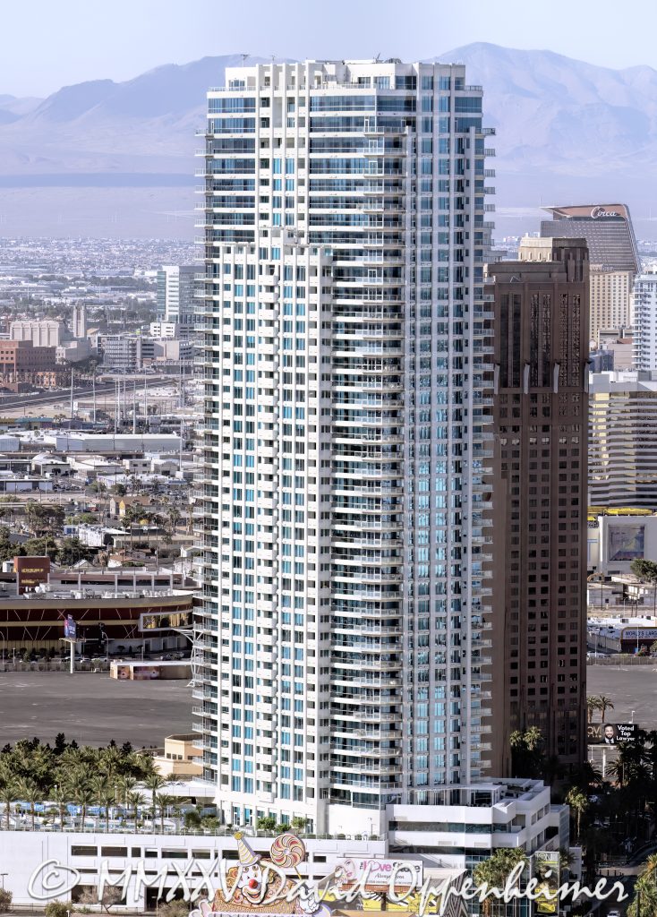 Sky Las Vegas Condominium Tower Aerial View Sky Las Vegas condominium tower at 2700 Las Vegas Blvd S on the Las Vegas Strip, a 45-story residential high-rise designed by Klai Juba Architects and built by M.J. Dean Construction, developed by Nevada Development Partners, completed in 2007. The 500-foot tower features luxury condominiums with private balconies, pool deck, and modern amenities — aerial view – © 2025 David Oppenheimer – Performance Impressions aerial photography archives – https://performanceimpressions.com The Metropolis LaSky Las Vegas, Sky Tower Las Vegas, 2700 Las Vegas Blvd S, Las Vegas Strip, Las Vegas, Nevada, Winchester, high rise, high-rise, condominium tower, condo tower, luxury condos, residential tower, balconies, architecture, architectural, Klai Juba, Klai Juba Wald, M.J. Dean Construction, Nevada Development Partners, Milbank Real Estate, Sahara, near Sahara, skyline, cityscape, tower, 45 story, 500 ft, elevation, aerial, aerial view, helicopter view, urban, urban landscape, real estate, residences, modernism, contemporary architecture, strip corridor, residential high rise, luxury living, amenities deck, pool deck, Las Vegas Boulevard, Paradise, Clark County, United States, USA, night lights, city lights, neon, desert city, south Strip, Nevada architecture, vertical, color, 1-14993092111