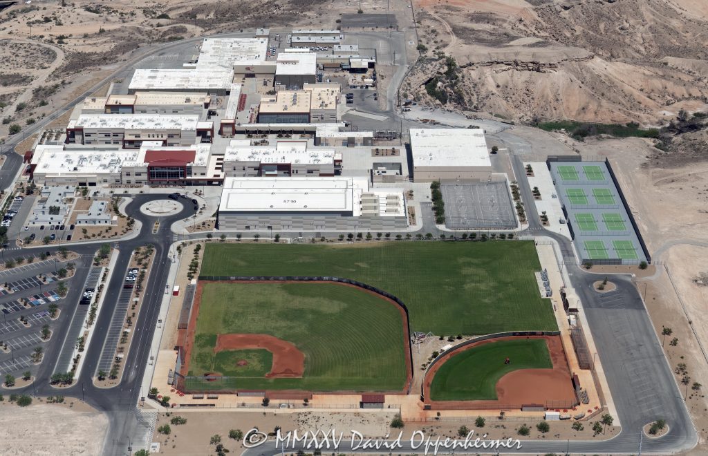 Southeast Career Technical Academy Las Vegas Campus Aerial View Southeast Career Technical Academy campus at 5710 Mountain Vista St in Las Vegas, Nevada, part of the Clark County School District. Designed by Simpson Coulter Studio and built under Phase II by Sletten Construction Co. Features multiple academy buildings, administrative and culinary-education wings, ball field, tennis courts, open courtyards, student and bus parking layout, desert-landscape setting — aerial view — © 2025 David Oppenheimer — Performance Impressions aerial photography archives — https://performanceimpressions.com Southeast Career Technical Academy, SECTA, 5710 Mountain Vista St, Las Vegas, Nevada, Clark County School District, Clark County, CCSD, school, campus, education campus, career technical school, academic building, administration building, culinary education, health sciences building, information technology building, ball field, tennis courts, student parking, bus parking, athletics, sports field, outdoor courts, layout, career training, careers, Career Technical Academy, Roadrunners, desert setting, desert landscape, aerial, aerial view, urban-education, training, education, vocational training, technical school, STEM, employees, teachers, students, workers, workforce preparation, high school, magnet school, modern architecture, collaborative courtyards, student commons, campus planning, school grounds, learning spaces, institutional architecture, Advanced Manufacturing, Architecture, Automotive, Construction, Cosmetology, Culinary Arts, Cybersecurity, Medical Professions, Multimedia, SECTA Stadium, Roadrunner Field, sports, ballpark, Sports Medicine, degrees, training, teaching, color, horizontal, 1-14993092111