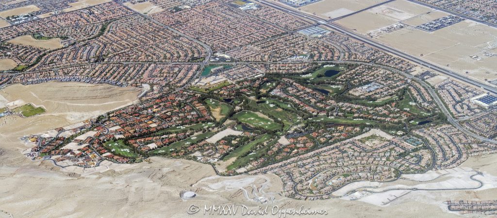 Southern Highlands Las Vegas Golf Community Aerial View Southern Highlands master-planned community and Southern Highlands Golf Club in Enterprise, Clark County, Nevada – featuring lush fairways, rolling greens, landscaped roads, gated neighborhoods, water features, and golf course terrain – aerial view – © 2025 David Oppenheimer – Performance Impressions aerial photography archives – https://performanceimpressions.com Southern Highlands, Southern Highlands Golf Club, master-planned community, gated community, luxury residential, championship, golf course, Las Vegas golf, Robert Trent Jones Sr., Robert Trent Jones Jr., Olympia Companies, Enterprise, Las Vegas Valley, Clark County, Nevada, homes, estates, fairways, greens, bunkers, water features, rolling terrain, landscaped roads, golfing, Vegas golf, golf community, residential development, private club, golf lifestyle, sports, recreation, outdoor sports, golfers, residences, residential, community layout, amenities, parks, tennis courts, walking paths, mountain views, desert setting, desert landscape, aerial, aerial view, horizontal, color, gated estates, real estate, neighborhood, green spaces, luxury homes, 1-14993092111