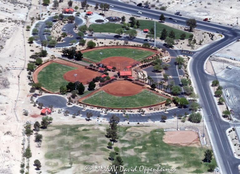 Stephanie Lynn Craig Park in Henderson, Clark County, Nevada – featuring ball fields, open grass areas, picnic shelters, playgrounds, walking paths, and landscaped community spaces within the Las Vegas Valley – aerial view – © 2025 David Oppenheimer – Performance Impressions aerial photography archives – https://performanceimpressions.com Stephanie Lynn Craig Park, Steph Lynn Park, Stephanie Lynn Park, park, city park, neighborhood park, Henderson, Clark County, Nevada, Las Vegas Valley, 1725 Galleria Dr, Galleria Drive, 89014, softball complex, ball fields, Las Vegas park, Vegas park, softball fields, baseball diamonds, backstops, dugouts, scoreboards, sports fields, athletics, recreation, outdoor sports, playground, play structures, swings, slides, shade, shade structures, picnic area, picnic shelters, picnic tables, barbecues, open grass, green space, walking paths, footpaths, loop path, trail, landscaping, trees, lawn, water conservation, xeriscape, restrooms, parking lot, community amenities, family-friendly, kids, youth sports, leagues, tournaments, practice fields, coaching, warm-up areas, bleachers, lights, field lighting, scoreboard, concession, pavilion, gazebo, memorial, dedication, City of Henderson, Parks and Recreation, municipal park, public park, park maintenance, park design, park planning, landscape architecture, landscape architect, park designer, site plan, urban park, suburban park, desert setting, desert landscape, aerial, aerial view, aerial photo, aerial photography, drone view, bird’s-eye view, horizontal, color, travel, tourism, visiting, neighborhood, local community, community gathering, open space, Southwest, American West, vertical, color, United States, 1-14993092111