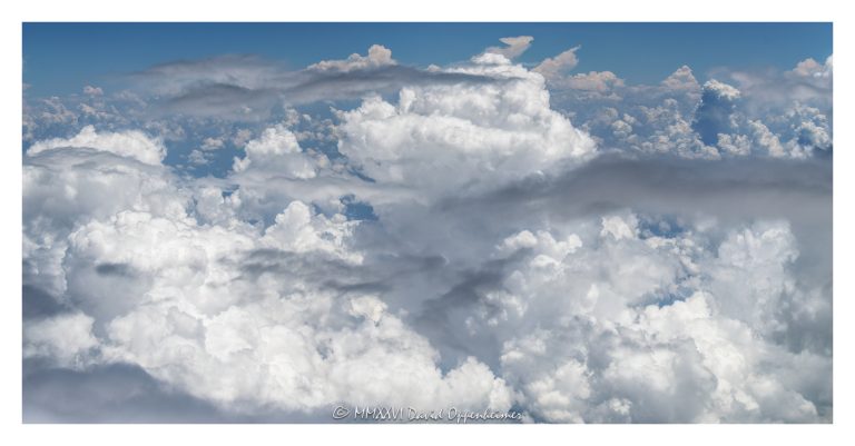 Summer clouds aerial photo showing towering cumulus clouds, developing cumulonimbus formations, and layered cloud tops against blue sky, emphasizing atmospheric texture, convective weather, cloud structure, and high-altitude meteorology – © 2026 David Oppenheimer – Performance Impressions aerial photography archives https://performanceimpressions.com summer clouds aerial photo, summer clouds, clouds aerial view, aerial clouds, cloudscape, cloudscape aerial, cloud formations, cloud tops, cloud layer, towering clouds, cumulus clouds, cumulus, cumulus congestus, cumulonimbus, cumulonimbus clouds, thunderstorm clouds, storm clouds, developing storm, convective clouds, convection, atmospheric convection, weather, meteorology, atmosphere, atmospheric, sky, blue sky, white clouds, cloud texture, cloud structure, cloud field, cloud cover, cloud mass, cloud bank, cloudscape photography, aerial, aerial photo, aerial photography, aerial photographer, aerial view, aerial image, high altitude, altitude, aviation, airplane view, flight, travel, summer weather, weather pattern, weather system, storm development, thunderstorm, rain clouds, moisture, humidity, vapor, water vapor, atmosphere science, weather science, meteorological, natural pattern, nature, outdoors, environment, climate, climate imagery, abstract nature, atmospheric layers, scenic sky, sky photography, United States, licensing, image licensing, commercial imagery, photography licensing, art, print, fine art, commercial photography, David Oppenheimer, horizontal, 1-15156784411