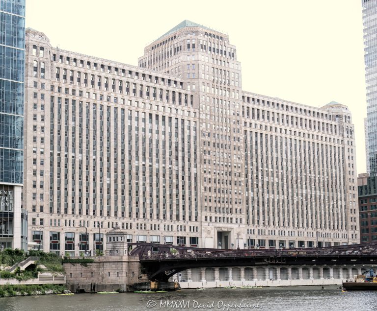 The Mart at 222 West Merchandise Mart Plaza faces the Chicago River in River North, with the Franklin–Orleans Street Bridge, the river, and River Park at THE MART visible in the foreground. Designed by Graham, Anderson, Probst & White with Alfred P. Shaw, the Art Deco landmark remains a major Chicago design, showroom, office, and riverfront real estate destination – © 2026 David Oppenheimer – Performance Impressions photography archives https://performanceimpressions.com The Mart, THE MART, Merchandise Mart, Merchandise Mart Chicago, The Mart Chicago, 222 W Merchandise Mart Plaza, 222 West Merchandise Mart Plaza, 222 Merchandise Mart Plaza, W Merchandise Mart Plaza, Merchandise Mart Plaza, Mart Plaza, River North, River North Chicago, downtown Chicago, Chicago Illinois, Chicago IL, 60654, Chicago River, river, riverfront, waterfront, Chicago riverfront, Chicago waterfront, Riverwalk, Chicago Riverwalk, The Jetty, The Mart River Park, River Park at The Mart, River Park, Franklin Orleans Street Bridge, Franklin–Orleans Street Bridge, Franklin Street Bridge, North Orleans Street Bridge, North Franklin Street Bridge, bridge, bascule bridge, Ogilvie Union, Ogilvie Union water taxi, water taxi, boat dock, facade, building exterior, exterior, Art Deco, Art Deco facade, limestone facade, terra cotta, commercial building, office building, showroom building, design center, design showrooms, furniture showrooms, trade showroom, building, architecture, architectural photography, Chicago architecture, Art Deco architecture, commercial architecture, riverfront architecture, real estate, Chicago real estate, commercial real estate, riverfront real estate, Vornado Realty Trust, Vornado, Marshall Field, Marshall Field family, Graham Anderson Probst White, Graham Anderson Probst & White, Alfred P Shaw, Alfred P. Shaw, Marshall’s Landing, Haworth, Chicago design, Chicago history, Illinois architecture, United States, licensing, image licensing, commercial imagery, photography licensing, art, print, fine art, commercial photography, David Oppenheimer, horizontal, 1-15156784411