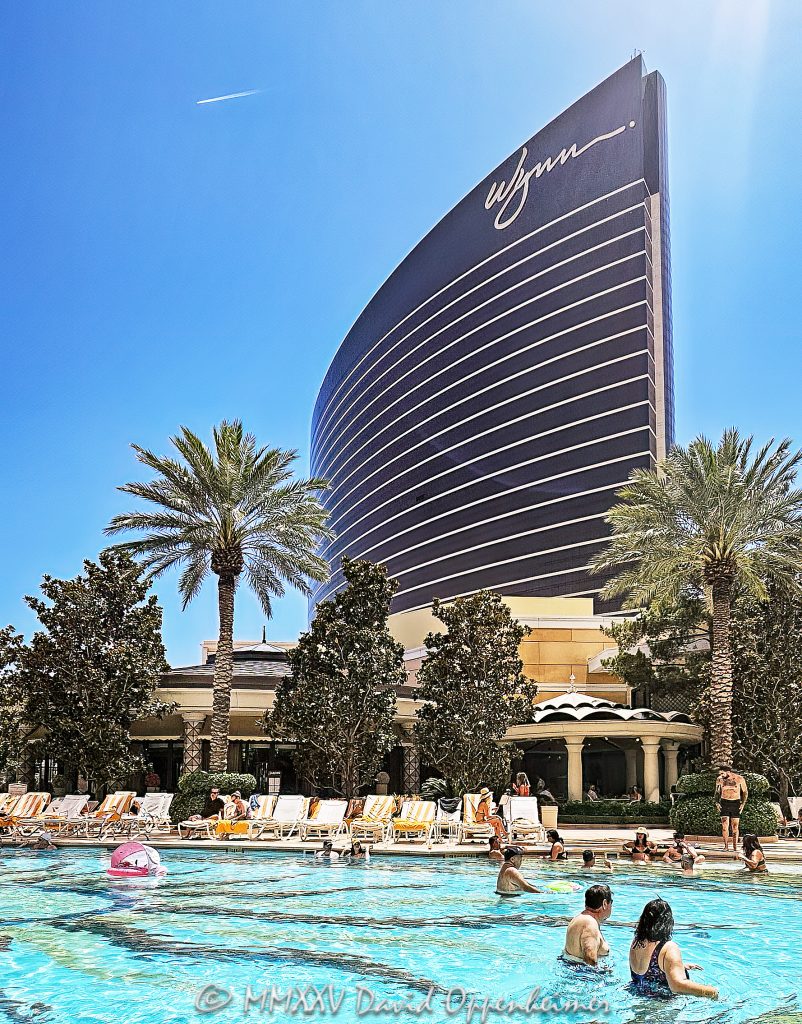 The Pool at Wynn Las Vegas Resort and Casino The Pool at the Wynn Las Vegas Resort and Casino in Las Vegas, Nevada – © 2025 David Oppenheimer – Performance Impressions Travel Photography Archives – https://performanceimpressions.com The Pool, Wynn Pool, pool, swimming, swim, swimmers, swimming pool, resort pool, poolside, pool deck, cabanas, daybeds, umbrellas, palm trees, gardens, landscaping, bridges, recreation, leisure, relaxation, dayclub, daylife, summer, vacation, entertainment, Wynn Las Vegas, Wynn, Wynn Resort, Wynn Casino, Wynn Resorts, Encore Las Vegas, Encore Resort, Encore Casino, Encore at Wynn, 3131 Las Vegas Blvd S, 89109, Las Vegas, Nevada, Las Vegas Strip, luxury resort, luxury hotel, five star, WYNN, WYNN stock, hospitality, resort design, architecture, landscape architecture, design, modern, contemporary, luxury lifestyle, reflections, water reflections, turquoise, blue, opulent, elegant, fine art photography, resort photography, travel photography, resort architecture, luxury travel, United States, USA, vertical, color, 1-14993092111