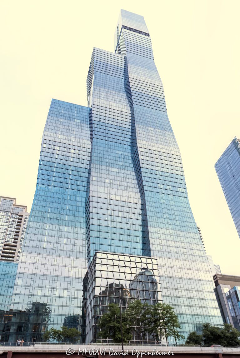 The St. Regis Chicago at 401 East Upper Wacker Drive rises above Lakeshore East as a 101-story luxury hotel and condominium tower viewed from the Chicago River. Designed by Jeanne Gang of Studio Gang, its three interconnected volumes and graduated blue-green glass curtain wall create a sculptural profile near Lake Michigan in Chicago, Illinois – © 2026 David Oppenheimer – Performance Impressions photography archives https://performanceimpressions.com The St. Regis Chicago, St. Regis Chicago, The St. Regis Chicago Hotel, St. Regis Hotel Chicago, St. Regis Chicago Residences, The Residences at The St. Regis Chicago, St. Regis Hotels & Resorts, 401 East Upper Wacker Drive, 401 E Upper Wacker Drive, 401 E Wacker Drive, 363 East Wacker Drive, 363 E Wacker Drive, Vista Tower, Vista Tower Chicago, Wanda Vista Tower, Lakeshore East, Lakeshore East Chicago, New Eastside, Chicago Loop, Loop Chicago, downtown Chicago, East Wacker Drive, Upper Wacker Drive, Wacker Drive, Chicago River, Chicago Riverwalk, Riverwalk, riverfront, Lake Michigan, Chicago lakefront, DuSable Harbor, Navy Pier, Millennium Park, Magnificent Mile, Chicago, Chicago Illinois, Chicago IL, Illinois, 60601, facade, building exterior, exterior, tower exterior, upper tower, glass facade, glass tower, glass skyscraper, glass curtain wall, curtain wall, gradient glass, blue-green glass, aqua glass, reflective glass, high-performance glass, faceted facade, geometric facade, undulating facade, sculptural facade, three-volume tower, interconnected volumes, three interconnected towers, frustum, frustum geometry, truncated pyramid, stacked frustums, stepped edges, tapered tower, contemporary architecture, modern architecture, sculptural architecture, high-rise architecture, riverfront architecture, Chicago architecture, architectural photography, luxury hotel, five-star hotel, Chicago hotel, Chicago luxury hotel, downtown hotel, downtown Chicago hotel, riverfront hotel, Lake Michigan hotel, Marriott hotel, hotel tower, hotel, hospitality, luxury hospitality, Marriott Bonvoy, Marriott International, Marriott stock, NASDAQ MAR, MAR stock, mixed-use tower, mixed-use building, condominium tower, residential tower, condominiums, luxury condos, luxury residences, Chicago condos, Lakeshore East condos, skyscraper, supertall, high rise, tower, building, 101-story tower, Chicago skyline, city views, river views, lake views, real estate, Chicago real estate, Lakeshore East real estate, hotel real estate, hospitality real estate, condominium real estate, residential real estate, luxury real estate, riverfront real estate, commercial real estate, Studio Gang, Jeanne Gang, bKL Architecture, bKL Architects, Gensler, HBA, Magnusson Klemencic Associates, MKA, McHugh Construction, Power Construction, OLIN, Magellan Development Group, Gencom, GD Holdings, hotel ownership, hotel investment, daytime, white sky, bright sky, soft light, boat view, river view, Chicago River cruise, architecture cruise, United States, licensing, image licensing, commercial imagery, photography licensing, art, print, fine art, commercial photography, David Oppenheimer, vertical, 1-15213827141