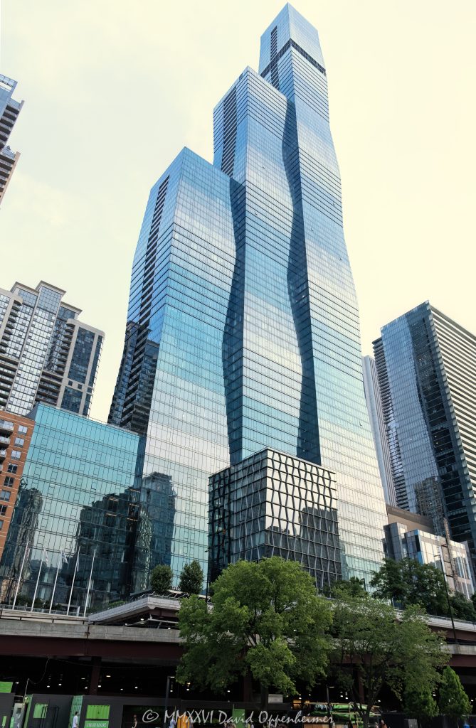 The St. Regis Chicago at 401 East Upper Wacker Drive rises above Lakeshore East as a 101-story luxury hotel and condominium tower viewed from the Chicago River. Designed by Jeanne Gang of Studio Gang, its three interconnected volumes and graduated blue-green glass curtain wall create a sculptural profile near Lake Michigan in Chicago, Illinois – © 2026 David Oppenheimer – Performance Impressions photography archives https://performanceimpressions.com The St. Regis Chicago, St. Regis Chicago, The St. Regis Chicago Hotel, St. Regis Hotel Chicago, St. Regis Chicago Residences, The Residences at The St. Regis Chicago, St. Regis Hotels & Resorts, 401 East Upper Wacker Drive, 401 E Upper Wacker Drive, 401 E Wacker Drive, 363 East Wacker Drive, 363 E Wacker Drive, Vista Tower, Vista Tower Chicago, Wanda Vista Tower, Lakeshore East, Lakeshore East Chicago, New Eastside, Chicago Loop, Loop Chicago, downtown Chicago, East Wacker Drive, Upper Wacker Drive, Wacker Drive, Chicago River, Chicago Riverwalk, Riverwalk, riverfront, Lake Michigan, Chicago lakefront, DuSable Harbor, Navy Pier, Millennium Park, Magnificent Mile, Chicago, Chicago Illinois, Chicago IL, Illinois, 60601, facade, building exterior, exterior, tower exterior, upper tower, glass facade, glass tower, glass skyscraper, glass curtain wall, curtain wall, gradient glass, blue-green glass, aqua glass, reflective glass, high-performance glass, faceted facade, geometric facade, undulating facade, sculptural facade, three-volume tower, interconnected volumes, three interconnected towers, frustum, frustum geometry, truncated pyramid, stacked frustums, stepped edges, tapered tower, contemporary architecture, modern architecture, sculptural architecture, high-rise architecture, riverfront architecture, Chicago architecture, architectural photography, luxury hotel, five-star hotel, Chicago hotel, Chicago luxury hotel, downtown hotel, downtown Chicago hotel, riverfront hotel, Lake Michigan hotel, Marriott hotel, hotel tower, hotel, hospitality, luxury hospitality, Marriott Bonvoy, Marriott International, Marriott stock, NASDAQ MAR, MAR stock, mixed-use tower, mixed-use building, condominium tower, residential tower, condominiums, luxury condos, luxury residences, Chicago condos, Lakeshore East condos, skyscraper, supertall, high rise, tower, building, 101-story tower, Chicago skyline, city views, river views, lake views, real estate, Chicago real estate, Lakeshore East real estate, hotel real estate, hospitality real estate, condominium real estate, residential real estate, luxury real estate, riverfront real estate, commercial real estate, Studio Gang, Jeanne Gang, bKL Architecture, bKL Architects, Gensler, HBA, Magnusson Klemencic Associates, MKA, McHugh Construction, Power Construction, OLIN, Magellan Development Group, Gencom, GD Holdings, hotel ownership, hotel investment, daytime, white sky, bright sky, soft light, boat view, river view, Chicago River cruise, architecture cruise, United States, licensing, image licensing, commercial imagery, photography licensing, art, print, fine art, commercial photography, David Oppenheimer, vertical, 1-15213827141
