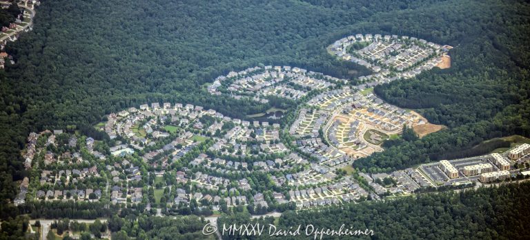 Tributary Village master planned community of single family homes in Douglasville, Georgia aerial view – © 2025 David Oppenheimer – Performance Impressions aerial photography archives – https://performanceimpressions.com Tributary, Tributary Village, Douglasville, The Village, The Village community, The Village Atlanta, The Village neighborhood, Atlanta, 30122, Georgia, Fulton County, residential, neighborhood, housing, community, subdivision, planned community, single family homes, houses, rooftops, cul de sac, driveways, streets, tree lined, landscaping, lawns, green space, trees, wooded, urban forest, residential development, homes, housing, Atlanta community, Atlanta neighborhood, real estate, aerial, aerial view, color, horizontal, United States, 1-14993092111