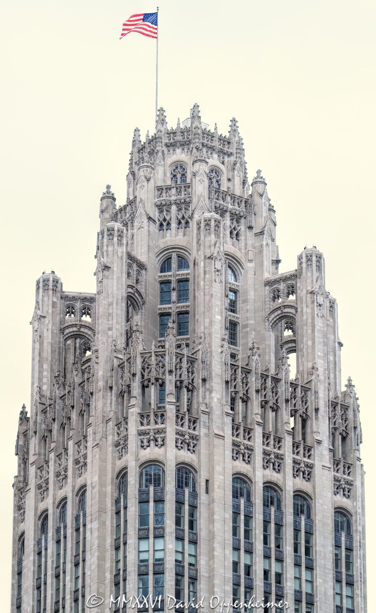 Tribune Tower at 435 North Michigan Avenue in Chicago shows the ornate neo-Gothic tower, limestone facade, Gothic crown, and architectural detailing of the former Chicago Tribune headquarters. Designed by John Mead Howells and Raymond Hood, the landmark tower has been converted into Tribune Tower Residences, a luxury condominium property developed by CIM Group and Golub & Company, with Rowan visible at Michigan Avenue street level – © 2026 David Oppenheimer – Performance Impressions photography archives https://performanceimpressions.com Tribune Tower, Tribune Tower Chicago, Tribune Tower Residences, Tribune Tower condos, Tribune Tower condominiums, 435 N Michigan Ave, 435 North Michigan Avenue, 435 N Michigan Avenue, North Michigan Avenue, Michigan Avenue, Magnificent Mile, Mag Mile, Chicago Loop, Streeterville, downtown Chicago, Chicago Illinois, Chicago IL, 60611, facade, building exterior, exterior, tower, Gothic tower, neo-Gothic tower, ornate tower, limestone facade, stone facade, Gothic facade, neo-Gothic facade, Gothic crown, architectural detail, ornate facade, historic facade, carved stone, buttresses, tracery, skyscraper, high rise, landmark building, Chicago Landmark, historic building, newspaper building, former headquarters, Chicago Tribune, Chicago Tribune Tower, Tribune Company, Tribune Media, Tribune Publishing, WGN Radio, real estate, Chicago real estate, luxury real estate, residential real estate, condominium tower, condo tower, luxury condos, condominiums, luxury residences, residential conversion, adaptive reuse, architecture, architectural photography, Chicago architecture, historic architecture, Gothic architecture, Gothic Revival, neo-Gothic architecture, commercial architecture, residential architecture, John Mead Howells, Raymond Hood, Howells and Hood, Howells & Hood, Rene Paul Chambellan, CIM Group, Golub and Company, Golub & Company, Rowan, Rowan Michigan Ave, Rowan Chicago, Tower District, Michigan Avenue retail, Chicago history, journalism history, Illinois architecture, United States, licensing, image licensing, commercial imagery, photography licensing, art, print, fine art, commercial photography, David Oppenheimer, vertical, 1-15213827141