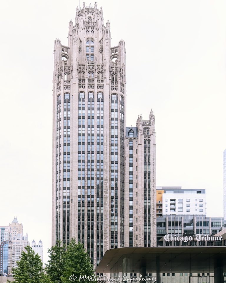 Tribune Tower at 435 North Michigan Avenue in Chicago shows the ornate neo-Gothic tower, limestone facade, Gothic crown, and architectural detailing of the former Chicago Tribune headquarters. Designed by John Mead Howells and Raymond Hood, the landmark tower has been converted into Tribune Tower Residences, a luxury condominium property developed by CIM Group and Golub & Company, with Rowan visible at Michigan Avenue street level – © 2026 David Oppenheimer – Performance Impressions photography archives https://performanceimpressions.com Tribune Tower, Tribune Tower Chicago, Tribune Tower Residences, Tribune Tower condos, Tribune Tower condominiums, 435 N Michigan Ave, 435 North Michigan Avenue, 435 N Michigan Avenue, North Michigan Avenue, Michigan Avenue, Magnificent Mile, Mag Mile, Chicago Loop, Streeterville, downtown Chicago, Chicago Illinois, Chicago IL, 60611, facade, building exterior, exterior, tower, Gothic tower, neo-Gothic tower, ornate tower, limestone facade, stone facade, Gothic facade, neo-Gothic facade, Gothic crown, architectural detail, ornate facade, historic facade, carved stone, buttresses, tracery, skyscraper, high rise, landmark building, Chicago Landmark, historic building, newspaper building, former headquarters, Chicago Tribune, Chicago Tribune Tower, Tribune Company, Tribune Media, Tribune Publishing, WGN Radio, real estate, Chicago real estate, luxury real estate, residential real estate, condominium tower, condo tower, luxury condos, condominiums, luxury residences, residential conversion, adaptive reuse, architecture, architectural photography, Chicago architecture, historic architecture, Gothic architecture, Gothic Revival, neo-Gothic architecture, commercial architecture, residential architecture, John Mead Howells, Raymond Hood, Howells and Hood, Howells & Hood, Rene Paul Chambellan, CIM Group, Golub and Company, Golub & Company, Rowan, Rowan Michigan Ave, Rowan Chicago, Tower District, Michigan Avenue retail, Chicago history, journalism history, Illinois architecture, United States, licensing, image licensing, commercial imagery, photography licensing, art, print, fine art, commercial photography, David Oppenheimer, vertical, 1-15213827141