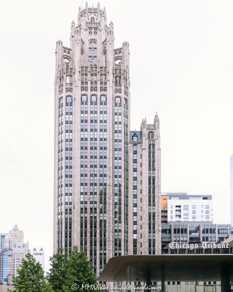 Tribune Tower at 435 North Michigan Avenue in Chicago shows the ornate neo-Gothic tower, limestone facade, Gothic crown, and architectural detailing of the former Chicago Tribune headquarters. Designed by John Mead Howells and Raymond Hood, the landmark tower has been converted into Tribune Tower Residences, a luxury condominium property developed by CIM Group and Golub & Company, with Rowan visible at Michigan Avenue street level – © 2026 David Oppenheimer – Performance Impressions photography archives https://performanceimpressions.com Tribune Tower, Tribune Tower Chicago, Tribune Tower Residences, Tribune Tower condos, Tribune Tower condominiums, 435 N Michigan Ave, 435 North Michigan Avenue, 435 N Michigan Avenue, North Michigan Avenue, Michigan Avenue, Magnificent Mile, Mag Mile, Chicago Loop, Streeterville, downtown Chicago, Chicago Illinois, Chicago IL, 60611, facade, building exterior, exterior, tower, Gothic tower, neo-Gothic tower, ornate tower, limestone facade, stone facade, Gothic facade, neo-Gothic facade, Gothic crown, architectural detail, ornate facade, historic facade, carved stone, buttresses, tracery, skyscraper, high rise, landmark building, Chicago Landmark, historic building, newspaper building, former headquarters, Chicago Tribune, Chicago Tribune Tower, Tribune Company, Tribune Media, Tribune Publishing, WGN Radio, real estate, Chicago real estate, luxury real estate, residential real estate, condominium tower, condo tower, luxury condos, condominiums, luxury residences, residential conversion, adaptive reuse, architecture, architectural photography, Chicago architecture, historic architecture, Gothic architecture, Gothic Revival, neo-Gothic architecture, commercial architecture, residential architecture, John Mead Howells, Raymond Hood, Howells and Hood, Howells & Hood, Rene Paul Chambellan, CIM Group, Golub and Company, Golub & Company, Rowan, Rowan Michigan Ave, Rowan Chicago, Tower District, Michigan Avenue retail, Chicago history, journalism history, Illinois architecture, United States, licensing, image licensing, commercial imagery, photography licensing, art, print, fine art, commercial photography, David Oppenheimer, vertical, 1-15213827141
