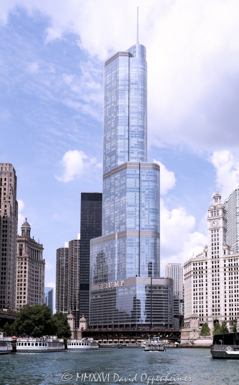 Trump International Hotel and Tower Chicago at 401 North Wabash Avenue rises along the Chicago River in River North, with the river and Wendella West Docks visible in the foreground. Designed by Skidmore, Owings & Merrill with Adrian Smith as lead architect and structural engineering by William F. Baker, the glass and stainless-steel mixed-use skyscraper includes hotel rooms, condominiums, retail space, and parking – © 2026 David Oppenheimer – Performance Impressions photography archives https://performanceimpressions.com