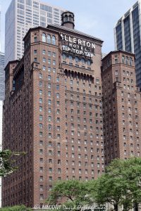 Warwick Allerton Chicago Hotel with the Tip Top Tap Sign Warwick Allerton Chicago at 701 North Michigan Avenue shows the historic Allerton Hotel Tip Top Tap sign mounted on its upper tower, framed by dark red brick, round-arched openings, pronounced setbacks, and rooftop towers. Designed by Murgatroyd & Ogden with Fugard & Knapp, the North Italian Renaissance hotel opened as the Allerton Hotel and is now part of Warwick Hotels & Resorts – © 2026 David Oppenheimer – Performance Impressions photography archives https://performanceimpressions.com Warwick Allerton Chicago, Warwick Allerton - Chicago, Warwick Allerton, Warwick Allerton Hotel, Warwick Allerton Hotel Chicago, Warwick Hotels & Resorts, Warwick Hotels and Resorts, Warwick Hotels, 701 North Michigan Avenue, 701 N Michigan Avenue, 701 N Michigan Ave, 701 North Michigan, Allerton Hotel Tip Top Tap, Allerton Hotel Tip Top Tap sign, Allerton Tip Top Tap, Tip Top Tap Allerton Hotel, Tip Top Tap sign, Tip Top Tap sign Chicago, Tip Top Tap Chicago, Tip Top Tap, Tip Top Tap Ballroom, Tip Top Tap Room, Tip Top Tap lounge, Allerton Hotel sign, Allerton rooftop sign, rooftop sign, hotel sign, historic sign, signage, lettering, Allerton Hotel, Allerton Hotel Chicago, The Allerton Hotel, former Allerton Hotel, Allerton Crowne Plaza Hotel, Allerton Crowne Plaza, Crowne Plaza Chicago, North Michigan Avenue, Michigan Avenue, Magnificent Mile, Mag Mile, Near North Side, downtown Chicago, Chicago Illinois, Chicago IL, 60611, facade, building exterior, exterior, upper tower, hotel facade, brick facade, dark red brick, red brick, decorative brick, historic facade, ornate facade, round arches, arched windows, arcades, carved stone, stone details, setbacks, rooftop towers, stepped tower, roofline, architectural detail, tower, high rise, skyscraper, building, hotel, historic hotel, landmark hotel, Chicago hotel, downtown hotel, Magnificent Mile hotel, hospitality, tourism, travel, real estate, Chicago real estate, hotel real estate, commercial real estate, Magnificent Mile real estate, architecture, architectural photography, Chicago architecture, North Italian Renaissance, Northern Italian Renaissance, Italian Renaissance, Renaissance Revival, historic architecture, hotel architecture, commercial architecture, Murgatroyd & Ogden, Murgatroyd and Ogden, Fugard & Knapp, Fugard and Knapp, Allerton House Company, Allerton House, club hotel, cocktail lounge, rooftop lounge, historic lounge, Chicago Landmark, Jazz Age, Roaring Twenties, Don McNeill, Breakfast Club radio show, historic Chicago, Rolex Boutique Bucherer Michigan Avenue, Rolex Boutique Chicago, Bucherer Michigan Avenue, Rolex Chicago, Rolex, luxury retail, retail, Illinois architecture, United States, licensing, image licensing, commercial imagery, photography licensing, art, print, fine art, commercial photography, David Oppenheimer, vertical, 1-15213827141