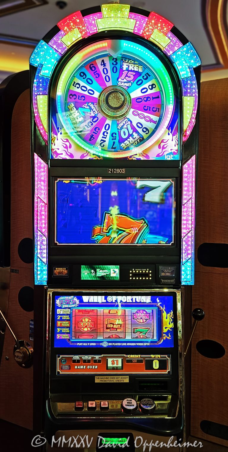 Wheel Of Fortune slot machine at The Venetian Casino by IGT in Las Vegas, Nevada - © 2025 David Oppenheimer - Performance Impressions casino photography archives - https://performanceimpressions.com Wheel Of Fortune slot machine, Wheel Of Fortune, wheel, Night Life, International Game Technology, IGT, slot machine, The Venetian, gaming, casino, Las Vegas, Nevada, slots, odds, win, gambling, wager, bet, luck, jackpot, gamble, quick spin, resort, American Gaming Association, AGA, 3355 S Las Vegas Blvd, 89109, bright, lights, colorful, United States, vertical, color, 1-14977862771