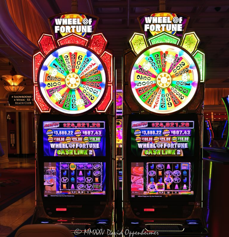 Wheel Of Fortune slot machines by IGT at Wynn Las Vegas Resort and Casino in Las Vegas, Nevada - © 2025 David Oppenheimer - Performance Impressions casino photography archives - https://performanceimpressions.com Wheel Of Fortune slot machine, Wheel Of Fortune, wheel, Night Life, International Game Technology, IGT, slot machines, slots, Wynn Casino, casino, gaming, play, betting, odds, win, gambling, wager, spin, good luck, bet, luck, gamble,3355 S Las Vegas Blvd, 89109, Wynn, Encore, Encore Las Vegas, Encore Resort, Encore Casino, Encore Vegas, Encore at Wynn, Wynn Las Vegas, Wynn Vegas, Wynn Resort, Wynn Resorts, 3131 Las Vegas Blvd S, 89109, hotel, resort, WYNN, WYNN stock, five star, five-star, luxury, Las Vegas, Vegas, Las Vegas Strip, jackpot, casino floor, entertainment, luxury gaming, Nevada casino, vacation, escape, dream, art, casino art, game show, Nevada, Nevada photography, colorful, United States, vertical, color, 1-14993092111