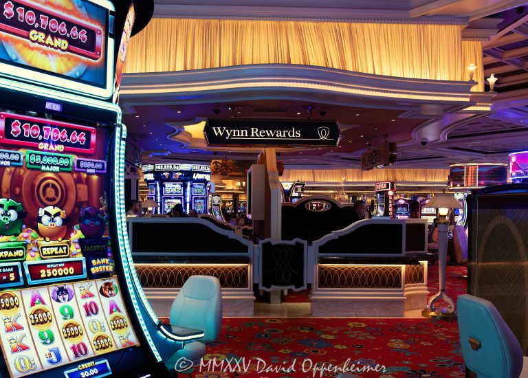 Wynn Rewards desk on the casino floor at Wynn Las Vegas Resort and Casino in Las Vegas, Nevada – © 2025 David Oppenheimer – Performance Impressions casino photography archives – https://performanceimpressions.com Wynn Rewards, Wynn Rewards desk, signage, staff, rewards, slot machines, slots, Wynn Casino, casino, gaming, play, betting, odds, win, gambling, wager, bet, luck, gamble, 3355 S Las Vegas Blvd, 89109, Wynn, players club, club, Encore, Encore Las Vegas, Encore Resort, Encore Casino, Encore Vegas, Encore at Wynn, Wynn Las Vegas, Wynn Vegas, Wynn Resort, Wynn Resorts, 3131 Las Vegas Blvd S, 89109, hotel, resort, WYNN, WYNN stock, five star, five-star, luxury, Las Vegas, Vegas, Las Vegas Strip, casino floor, entertainment, luxury gaming, Nevada casino, vacation, art, casino art, concierge, desk, card, Nevada, Nevada photography, lighting, colorful, United States, vertical, color, 1-14993092111